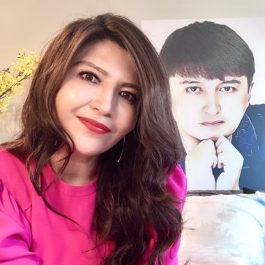 Rayhan is pictured in front of an image of her brother Ekpar.
