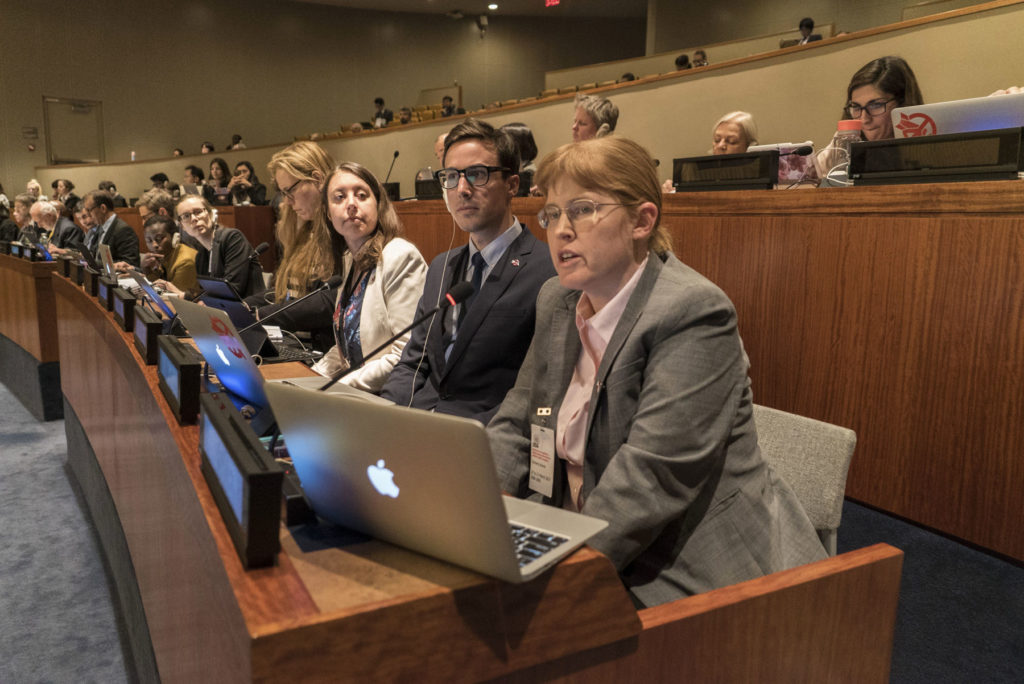 Bonnie Docherty and several students sit at a panel during a UN negotiating session.
