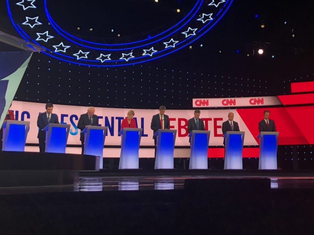 Democratic candidates stand at respective podiums at the Democratic Presidential Debate in Detroit, MI.