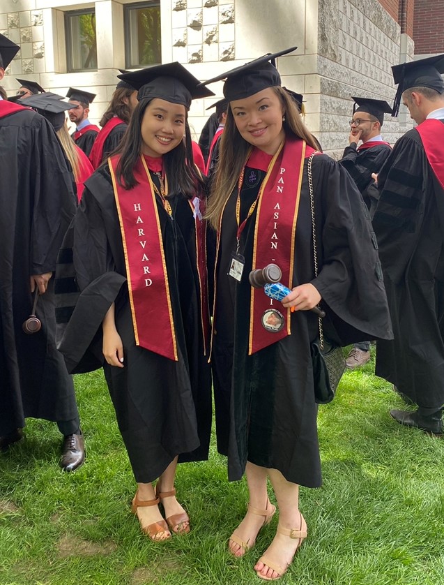 Monica Lee and Erica Holmberg in caps and gowns at HLS graduation