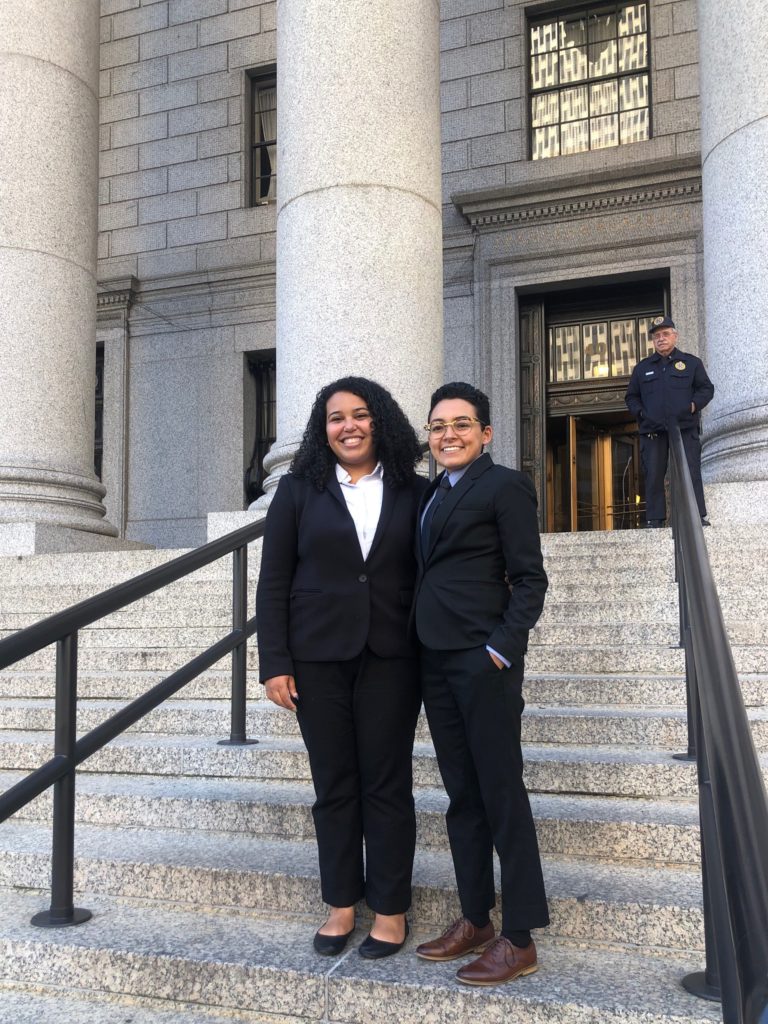Two students stand on the front steps of the Appeals Court