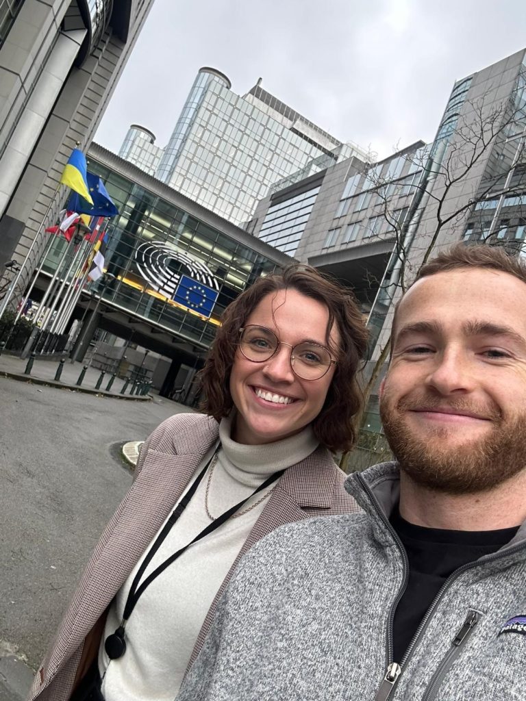 A selfie of Michael and Hannah in front of government buildings